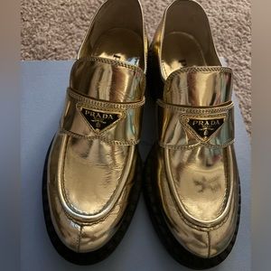 Prada 
Metallic leather loafers gold, just a few times gently used